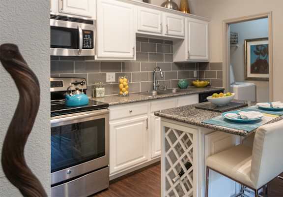This is a photo of the kitchen in the 826 square foot 1 bedroom , 1 bath apartment at The Brownstones Townhome Apartments in Dallas, TX.