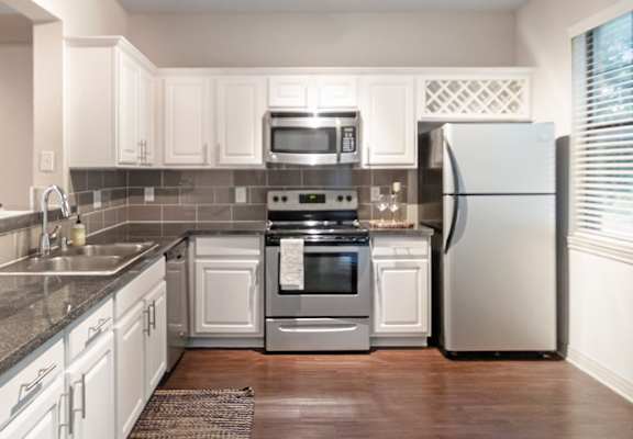 This is a photo of the kitchen of the 1661 square foot 3 bedroom, 3 and a half bath floor plan at The Brownstones Townhome Apartments in Dallas, TX.