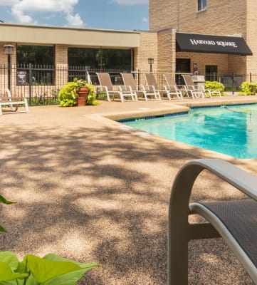 This is a photo of the pool area in the courtyard at Harvard Square Apartments, in the Vickery Meadow neighborhood of Dallas, TX.
