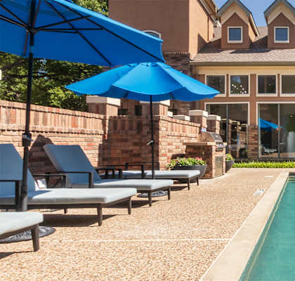 This is a photo of the pool area at The Brownstones Townhome Apartments in Dallas, TX.