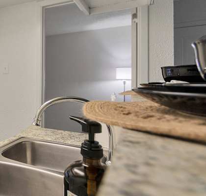 This is a photo of the kitchen in the 477 square foot 1 bedroom apartment at Canyon Creek Apartments in Dallas, TX.