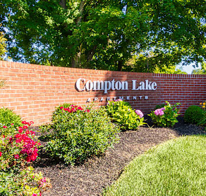 Community entrance near the private stocked fishing pond at Compton Lake Apartments