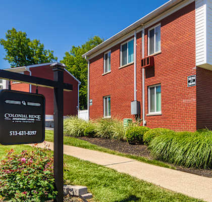 Community sign and brick apartment buildings at Colonial Ridge Apartments in Cincinnati, Ohio