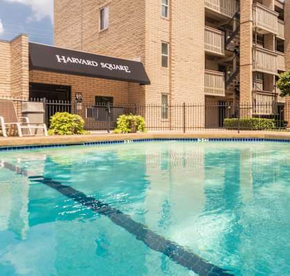 This is a photo of the pool area in the courtyard at Harvard Square Apartments, in the Vickery Meadow neighborhood of Dallas, TX.