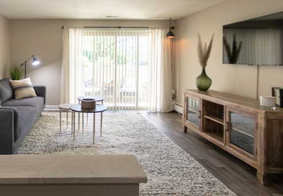 This is picture of the living room and patio in the 823 square foot 2 bedroom apartment at Aspen Village, Cincinnati, OH