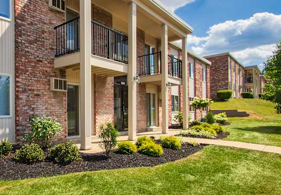 A row of red brick apartment buildings with balconies at Blue Grass Manor Apartments in Erlanger, KY..