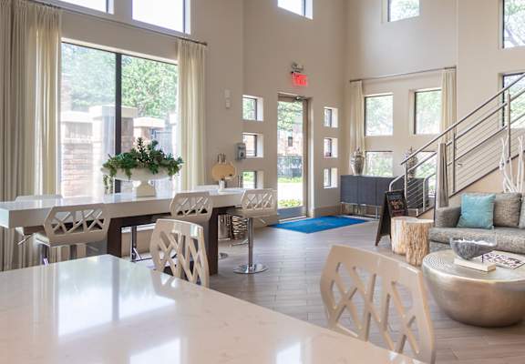 A living room with a grey couch and a white table.