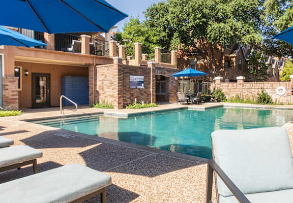 This is a photo of the pool area at The Brownstones Townhome Apartments in Dallas, TX.