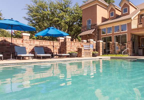 This is a photo of the pool area at The Brownstones Townhome Apartments in Dallas, TX.