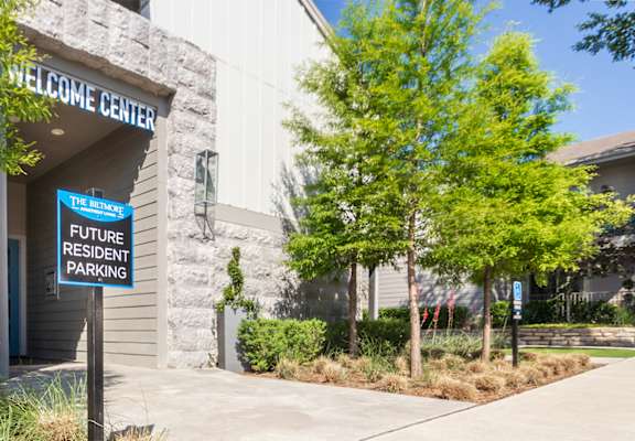 A building with a sign that says "Welcome Center" and "Future Resident Parking".