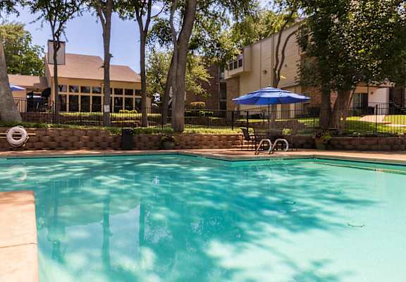 This is a photo of the pool area at Canyon Creek Apartments in Dallas, TX.
