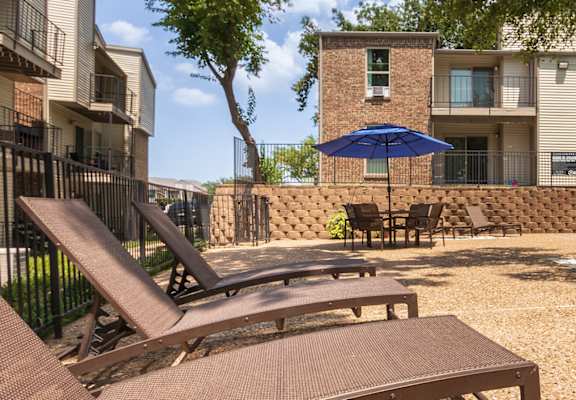 This is a photo of the pool area at Canyon Creek Apartments in Dallas, TX.