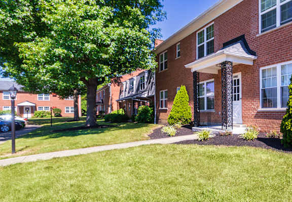 Community building exterior with landscaped entry and green space in Mount Healthy, OH