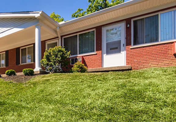 Covered, private apartment entrances and well-kept lawn at Colonial Ridge Apartments in Cincinnati