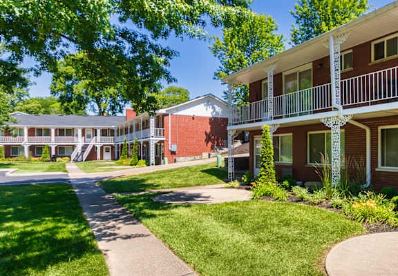 Courtyard walkway and two-story apartment building with balconies at Colonial Ridge Apartments