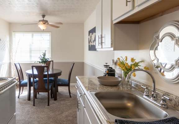 This is a picture of the kitchen and dining room in the 850 square foot, 1 bedroom, 1 bath apartment at Fairfield Pointe Apartments in Fairfield, Ohio.