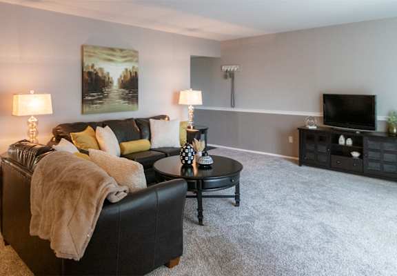 This is a picture of the living room in the 980 square foot, 2 bedroom, 1 bath model apartment at Fairfield Pointe Apartments in Fairfield, Ohio.