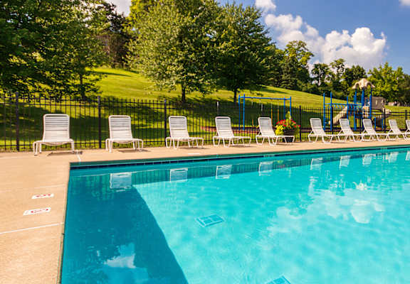 A large swimming pool with lounge chairs at Fairfield Pointe Apartments in Fairfield, Ohio.