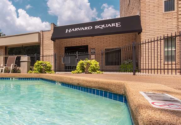 This is a photo of the pool area in the courtyard at Harvard Square Apartments, in the Vickery Meadow neighborhood of Dallas, TX.