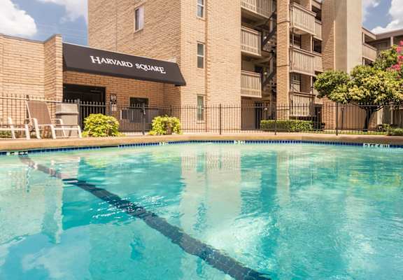 This is a photo of the pool area in the courtyard at Harvard Square Apartments, in the Vickery Meadow neighborhood of Dallas, TX.