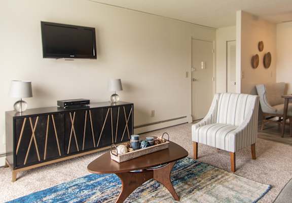 Living room with dining area and patio access in a Lisa Ridge apartment home