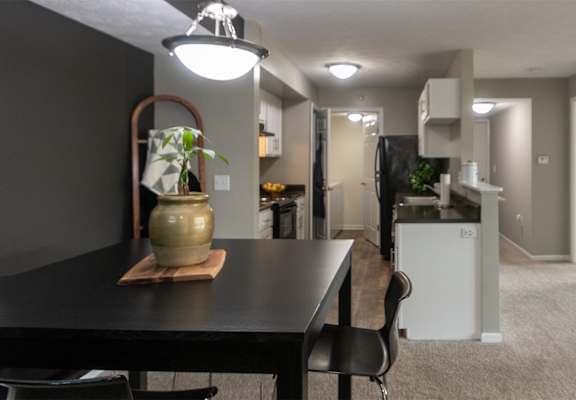 This is a photo of the kitchen and living room from the dining room in the 1226 square foot 3 bedroom, 2 bath Hambletonian at Trails of Saddlebrook Apartments in Florence, KY.