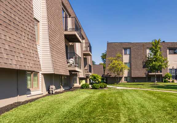 Open green lawn and courtyard view between apartment buildings at Village East Apartments