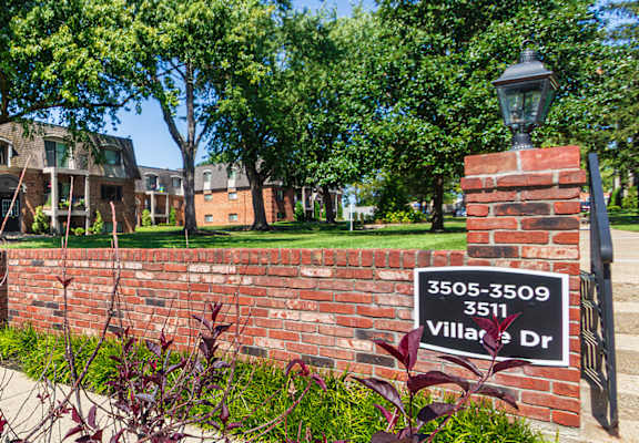 A brick wall with a sign that says 3509-3509 Villas Dr.