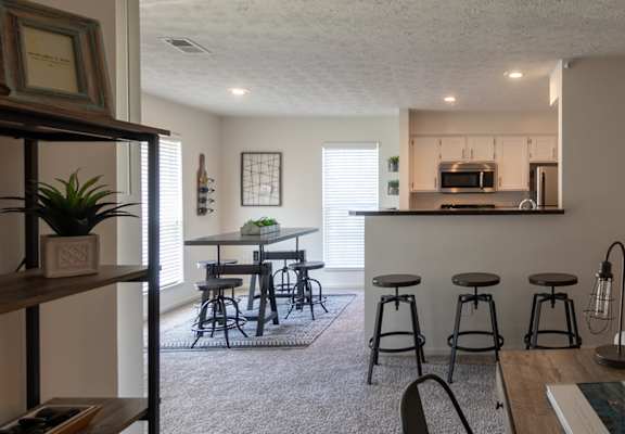 This is a photo of the kitchen and dining rooms from the living room in the 1100 square foot 2 bedroom Kettering floor plan at Washington Park Apartments in Centerville, OH.