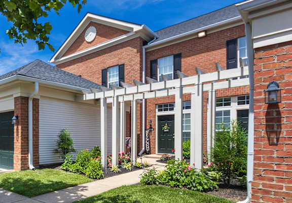 A house with a red brick exterior and a white garage door.