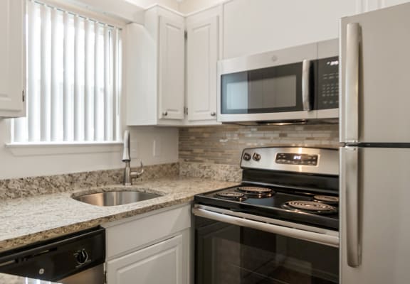 This is a photo of the kitchen in the 450 square foot efficiency apartment at Cambridge Court Apartments in Dallas, TX.