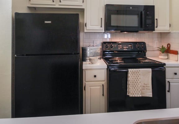 Photo of the kitchen in a 692 square foot 1 bed, 1 bath model aprtment at Cambridge Court Apartments in Dallas Texas