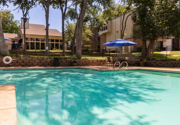 This is a photo of the pool area at Canyon Creek Apartments in Dallas, TX.