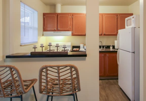This is a photo of the kitchen room of the 550 square foot 1 bedroom, 1 bath, balcony floor plan model apartment at College Woods Apartments in Cincinnati, OH.