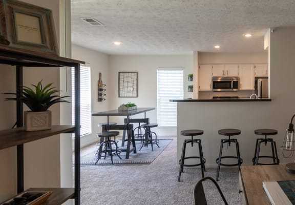 This is a photo of the kitchen and dining rooms from the living room in the 1100 square foot 2 bedroom Kettering floor plan at Washington Park Apartments in Centerville, OH.