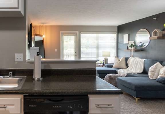 This is a photo of the living room from the kitchen in the 1226 square foot 3 bedroom, 2 bath Hambletonian at Trails of Saddlebrook Apartments in Florence, KY.