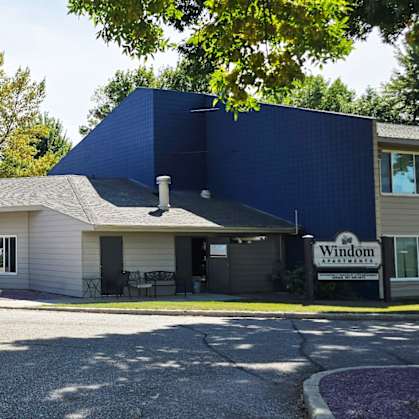 A large blue building with a sign that says "Windemere" in front of it.