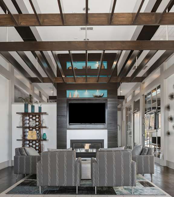 A modern dining room with a wooden table and chairs.