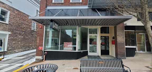 A storefront with a black awning and a sign that says "SPACE".