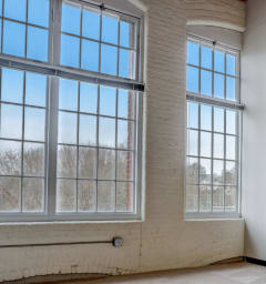 an empty room with three large windows