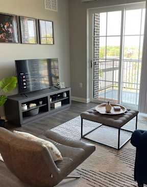 a living room with a couch and a chair and a television