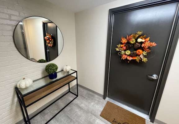 A black door with a wreath on it.