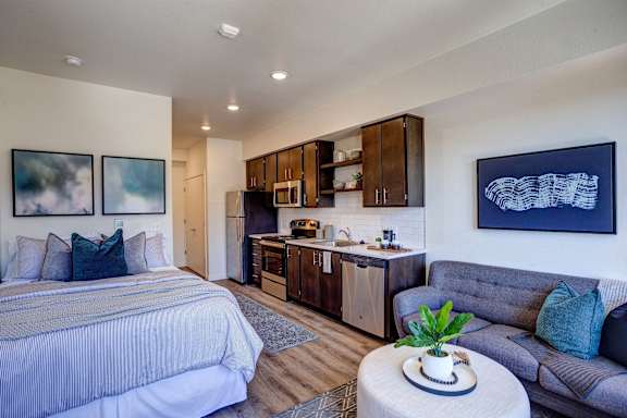Living and cozy bed at Commons at Sylvan Canyon Apartments, Portland, Oregon