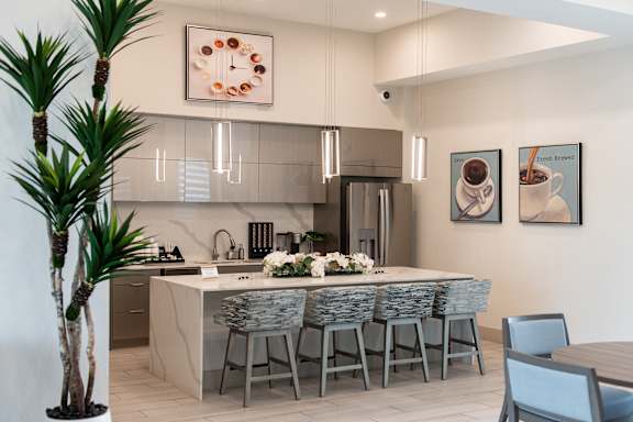 A modern kitchen with a dining table set for six.