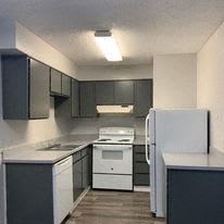 a kitchen with a stove and a refrigerator