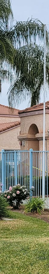 a house with a blue fence in front of it