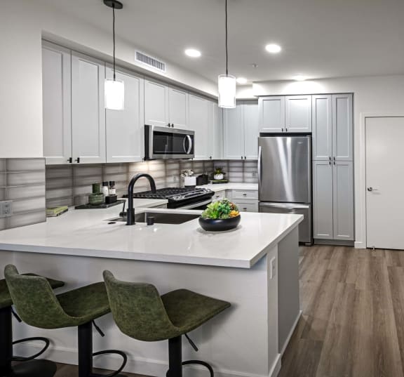 a kitchen with white cabinets and a marble at Luma at El Corazon Apartments, Oceanside, 92056
