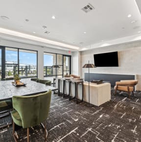 a conference room with a table and chairs and a television