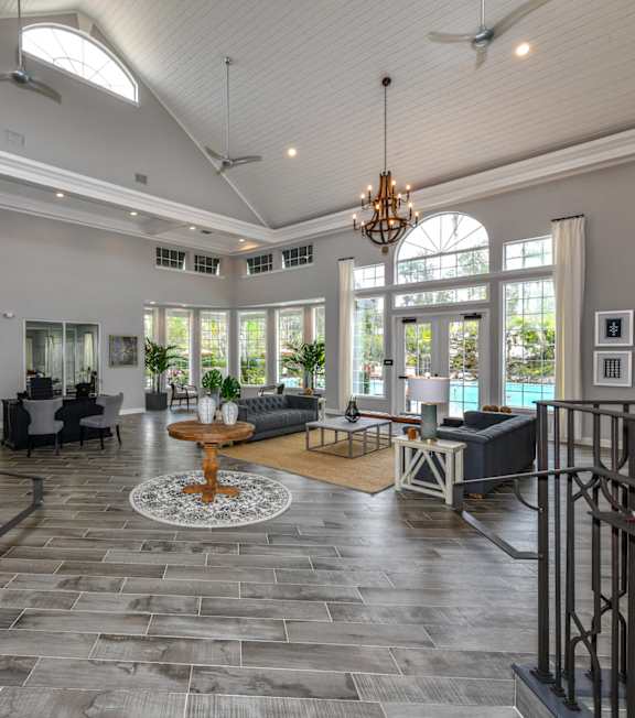 A spacious gym with a variety of equipment and a large window. at Park Place Oviedo Apartments, Oviedo, FL