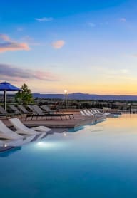a sunrise over a swimming pool at the resort